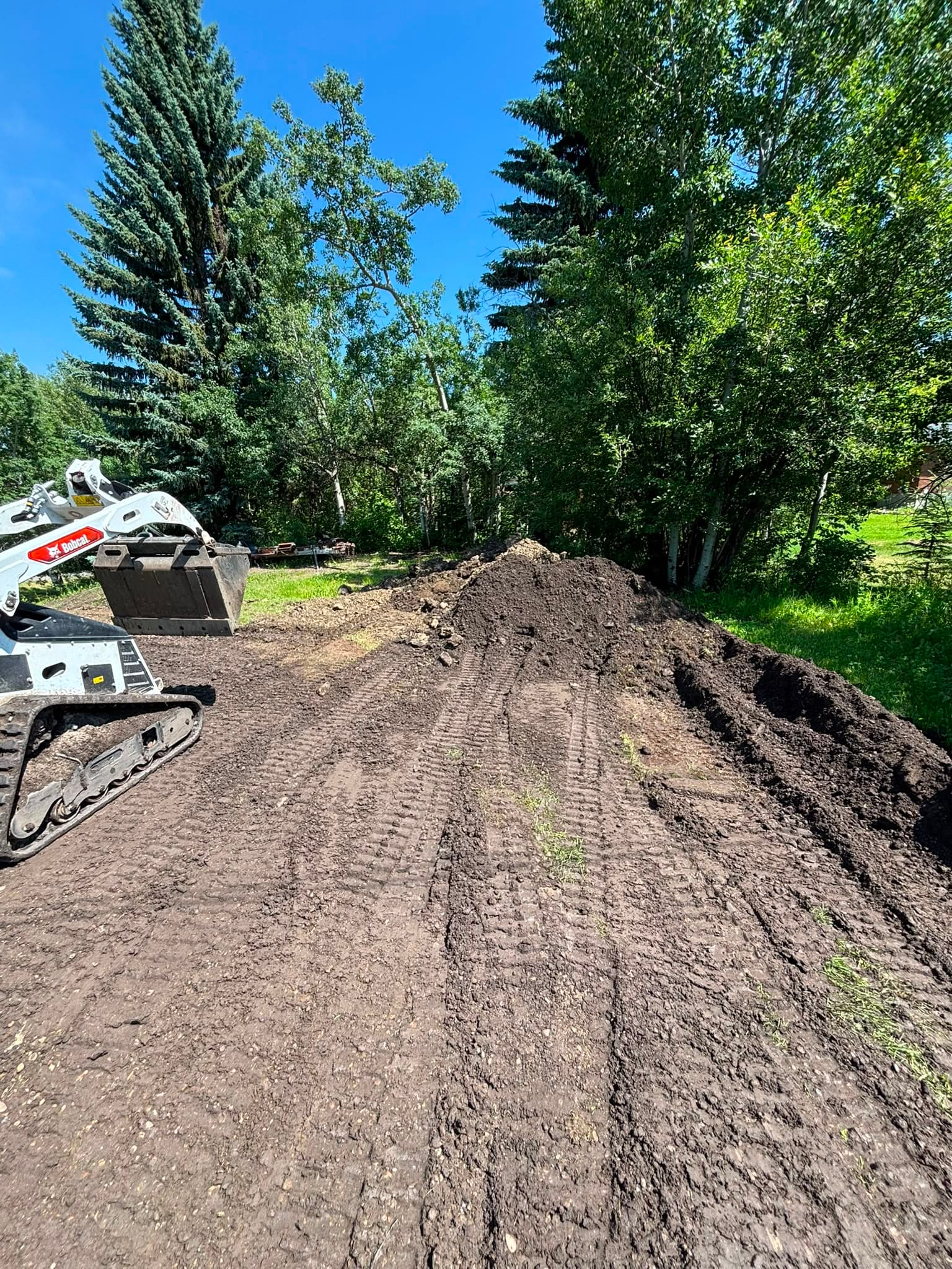 Spreading and grading topsoil on an Alberta acreage